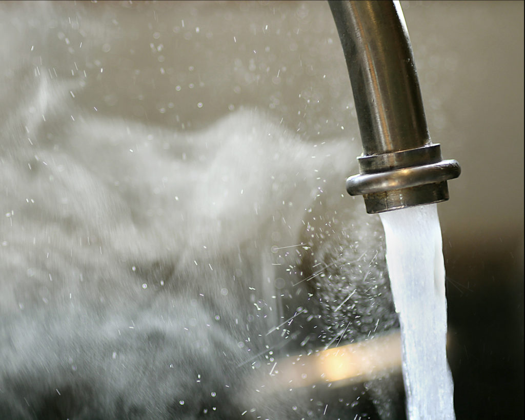 Hot steaming running tap water